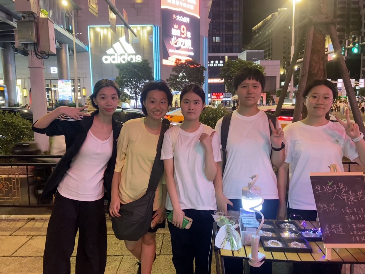 Club members at the night flower stall, Qixi 2025