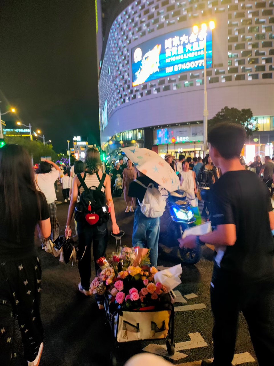 Wheeling the flower cart through the night market, Qixi 2026